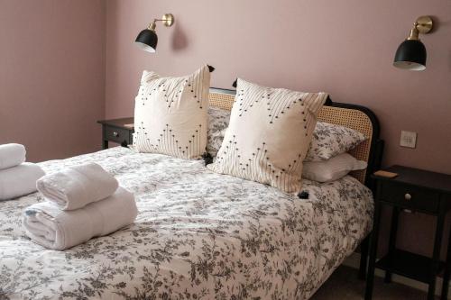 a bedroom with a bed with pillows on it at Cosy Lake District Cottage in Staveley