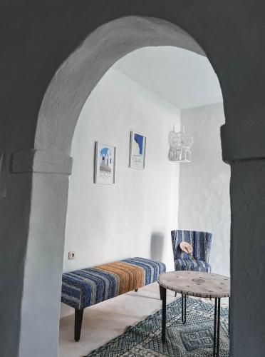 a room with a bed and a chair and a table at Dar Naël in Houmt Souk