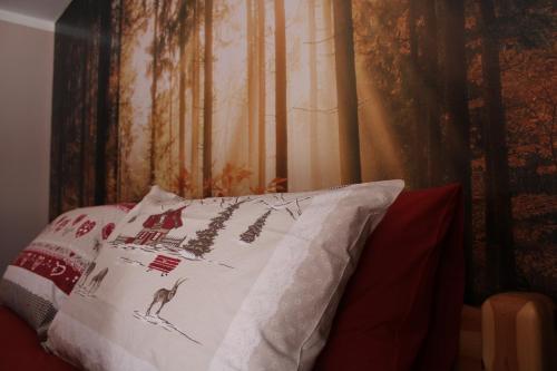 a pillow sitting on top of a bed next to a wall at I profumi del bosco in Enego
