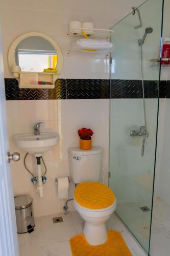 a bathroom with a toilet and a glass shower at Royal Terrace I (Queen ) in San Felipe de Puerto Plata