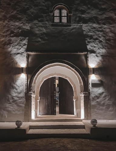 an archway leading to a building at night at Dar Naël in Houmt Souk