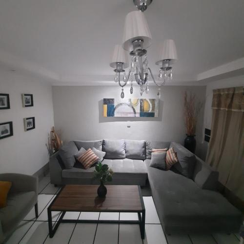 a living room with a couch and a table at Casa Blanca Posadas in Posadas