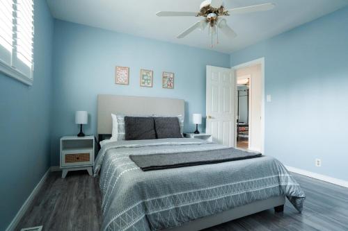 ein blaues Schlafzimmer mit einem Bett und einem Deckenventilator in der Unterkunft Neptunes Hideaway in Tobermory