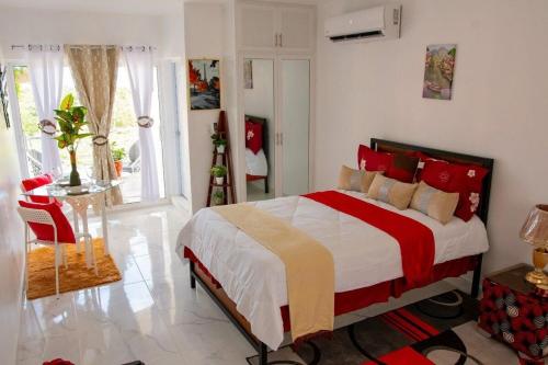 a bedroom with a large bed with red pillows at Royal Terrace III (Prince) in San Felipe de Puerto Plata