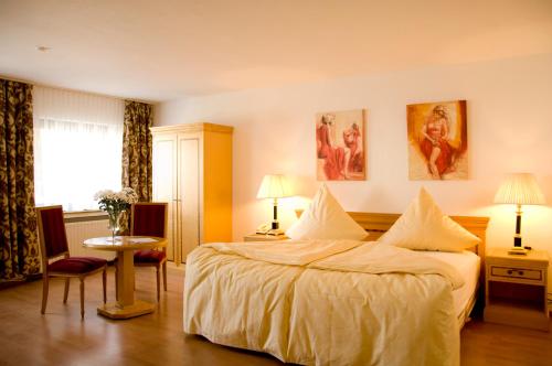 a hotel room with a large bed and a window at Hotel Kölner Hof Refrath in Bergisch Gladbach