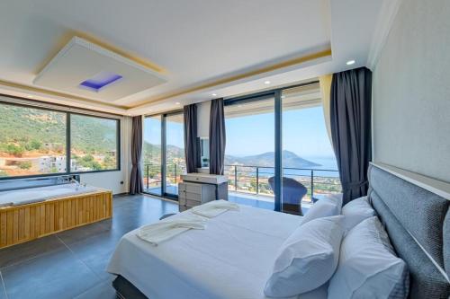 a bedroom with a bed and a large window at Hadi Villa in Kalkan