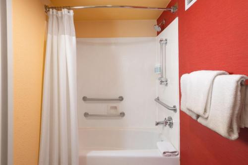 a bathroom with a shower and a white sink at Courtyard by Marriott Dallas Plano in Legacy Park in Plano