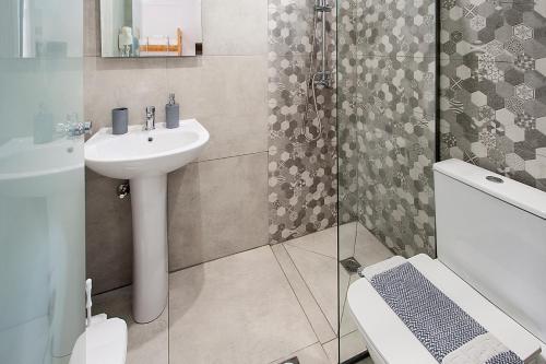 a bathroom with a sink and a toilet and a shower at ELIZA Skiathos in Skiathos Town