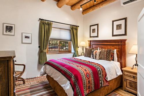 a bedroom with a bed and a window at Amor - Historic Adobe, Amazing Location in Santa Fe