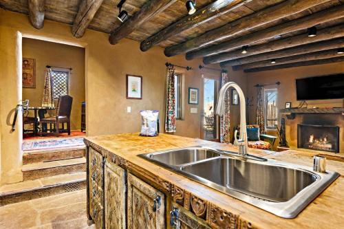 a kitchen with a sink and a fireplace at Artesano in Santa Fe