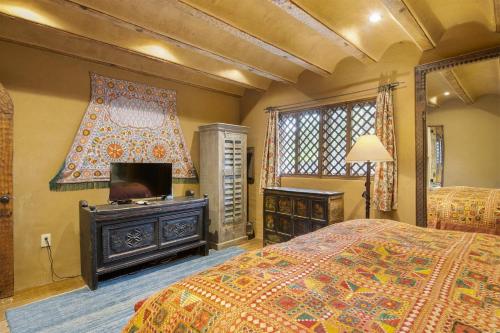a bedroom with two beds and a flat screen tv at Artesano in Santa Fe