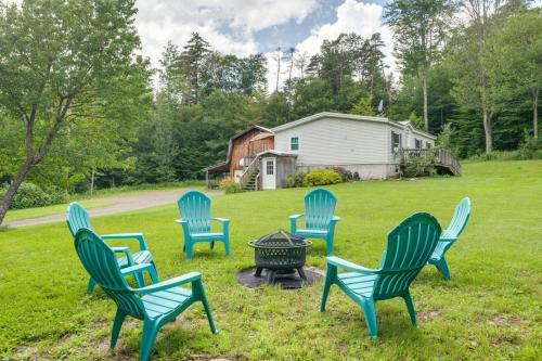 a group of chairs around a fire pit in a yard at Otego Home with Hot Tub Near All Star Village! in Oneonta