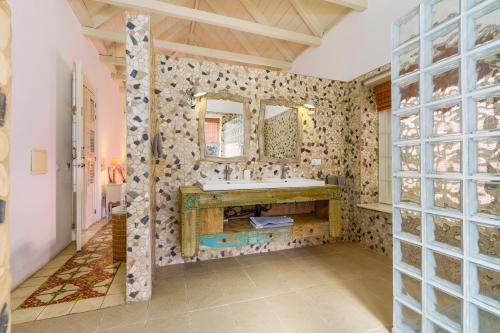 a bathroom with a sink and a mirror at Villa Tokara Boutique Hotel in Willemstad