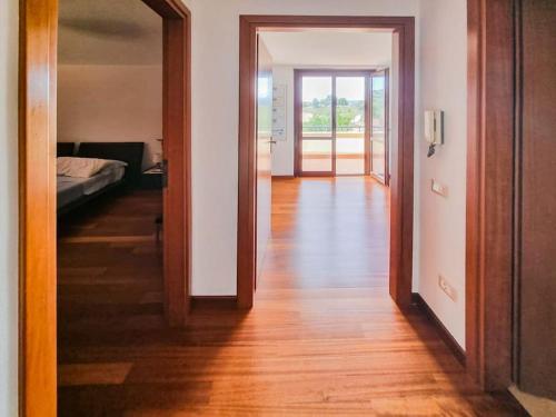 a hallway with a door open to a room with a bed at Casa Luca 1C in Sasso