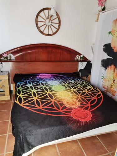 a bed with a painting on top of it at ROSA in Llaurí