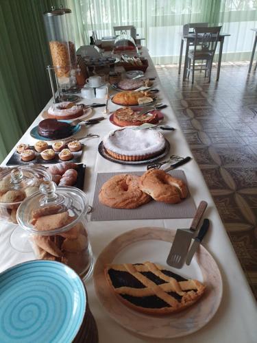 a long table filled with different types of pastries at Hotel Ristorante Tre Stelle in Montepulciano