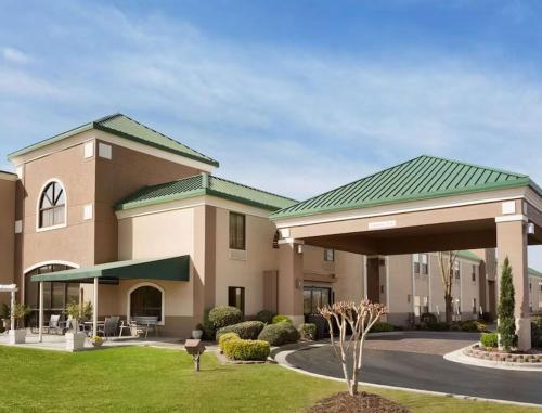 a large building with a green roof at Spark by Hilton Spring Lake Fayetteville in Spring Lake