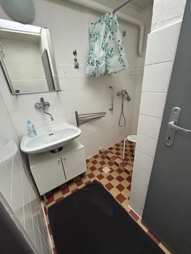 a bathroom with a sink and a mirror at Cibak House in Liptovský Mikuláš