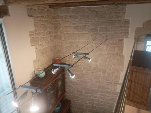 a light fixture hanging from a brick wall at Casa Vacanze Il Geco in Trani
