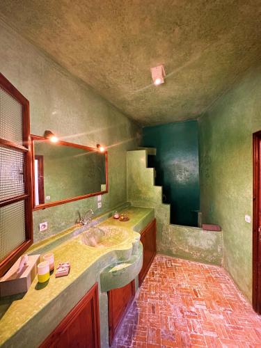a bathroom with a sink and a mirror at Les Terrasses d'Essaouira - Yoga Studio in Essaouira