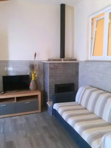 a room with two beds and a tv and a fireplace at Immaculate 1-Bed Apartment in Zubovici Croatia in Zubovići