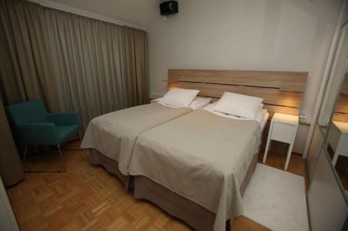 Postel nebo postele na pokoji v ubytování Katajaranta Apartment - Aula