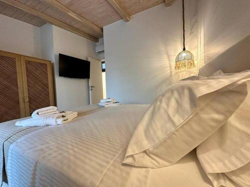 a bedroom with a bed with towels on it at Milva by Goutos Luxury Living in Agios Aimillianos