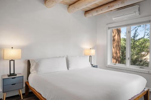 a bedroom with a white bed and a window at Casa Anita in Santa Fe