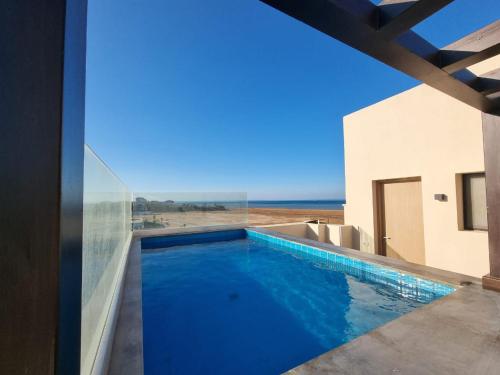 a swimming pool with a view of the desert from a house at Fanadir Marina Elgouna villa in Hurghada