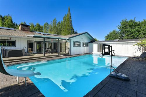 a swimming pool in front of a house at Casa De Kai in Mill Bay