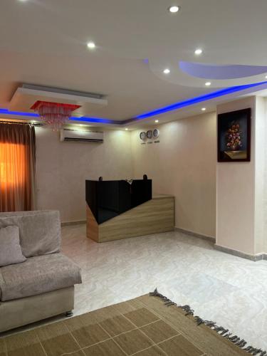 a living room with a couch and a television at Pyramids Desert Gate Hotel in ‘Ezbet `Abd el-Ḥamîd