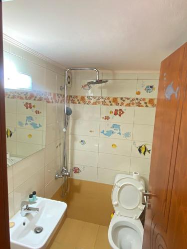 a bathroom with a shower and a toilet and a sink at Anna's room in Archanes