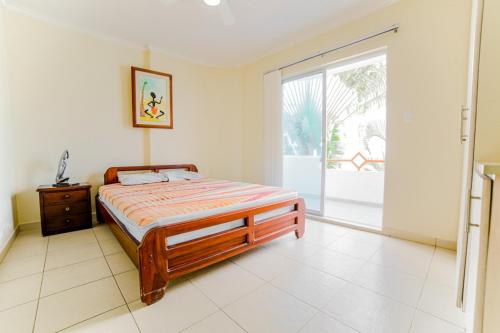 a bedroom with a bed and a sliding glass door at DPTOS - SIEMPRE DE RELAX in Tonsupa