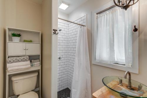 a bathroom with a shower and a glass sink at Cozy Tennessee Retreat with Patio and Charcoal Grill! in Linden
