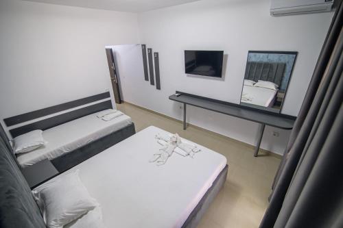 a small room with two beds and a mirror at Cazare Dumbrava in Eforie Sud