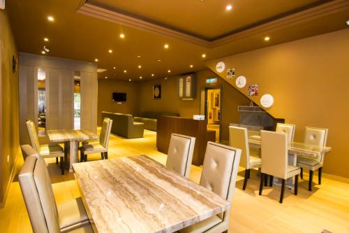 a dining room with a table and chairs at 888 Boutique Hotel in Batu Pahat