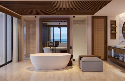a bathroom with a large tub in the middle of a room at Secrets Playa Blanca Costa Mujeres - All Inclusive Adults Only in Cancún