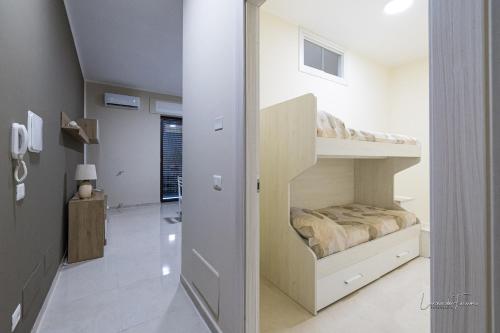 a small bedroom with a bunk bed and a hallway at Casa Vacanza Egan Scanzano J in Scanzano