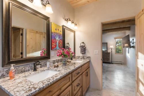 a bathroom with two sinks and a large mirror at Linda - Walk to The Plaza in Santa Fe