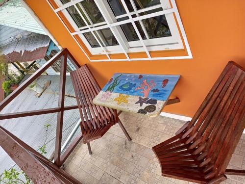 a table and two chairs on a balcony with a table at Surfari Bocas in Bocas del Toro
