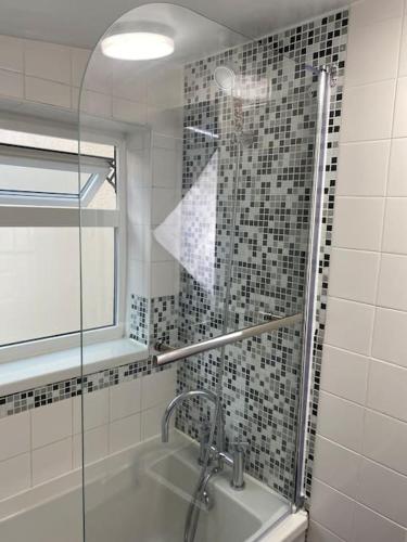 a bathroom with a shower with a sink and a shower at House in Medway in Gillingham