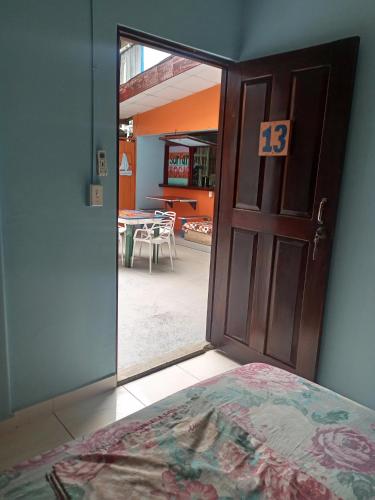 a bedroom with a door with a view of a patio at Surfari Bocas in Bocas del Toro