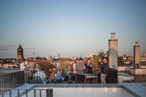 a group of people standing on top of a roof at The Circus Apartments in Berlin