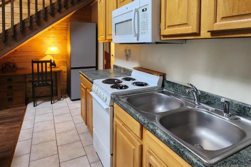 a kitchen with a sink and a stove at Buffalo Beauty in Granby