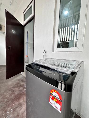a kitchen with a counter with a mirror on it at Queen’s Villa for 28Pax @Central of Penang in Jelutong