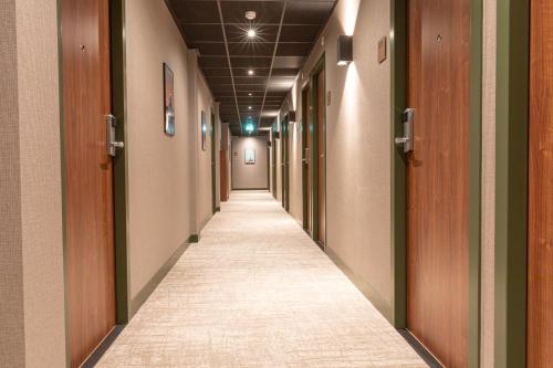 a hallway of an office building with a long corridor at Distrikt Hotels Amsterdam Zaandam in Zaandam