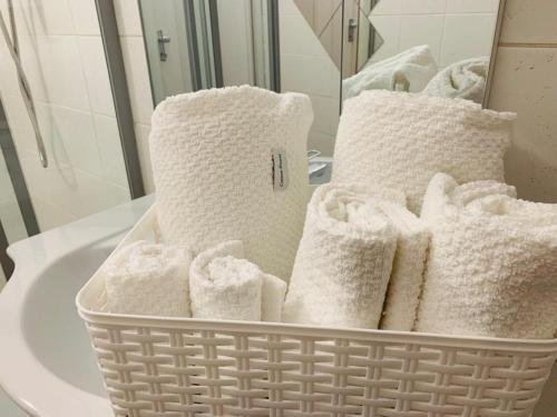 a basket of towels sitting on a bathroom sink at Il Cortiletto in Somma Lombardo