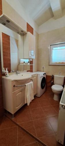 a bathroom with a sink and a washing machine at Apartments Villa Bella Vista Hvar in Hvar