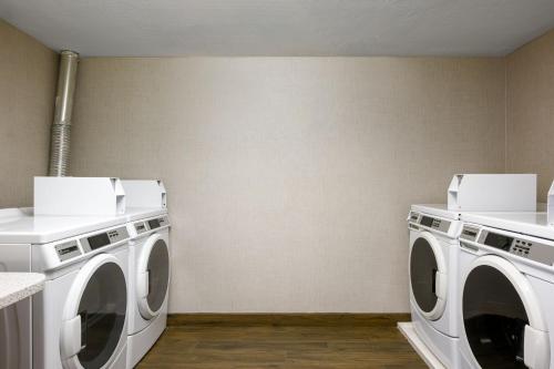 two white washing machines in a laundry room at Residence Inn by Marriott Salt Lake City Downtown in Salt Lake City