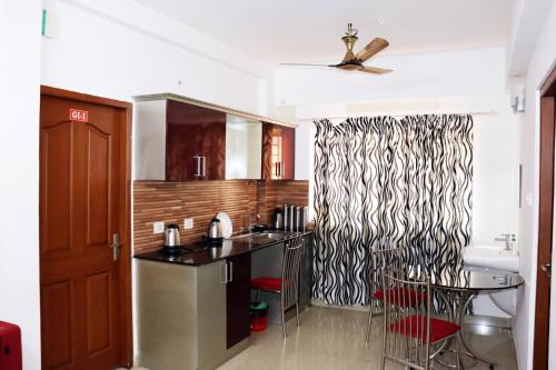 a kitchen with a sink and a counter top at Uthradam towers in Trivandrum